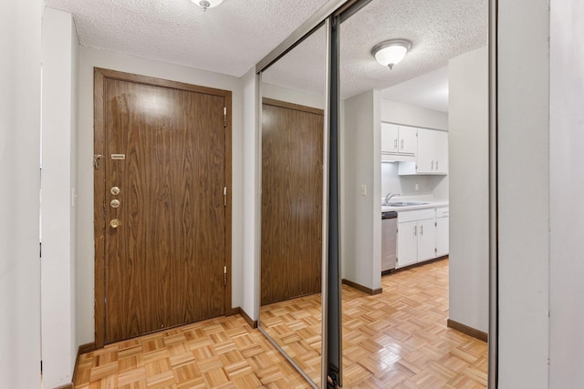 450 Ford Rd Unit 231, Saint Louis Park, MN 55426 - hall featuring a sink, a textured ceiling, and baseboards