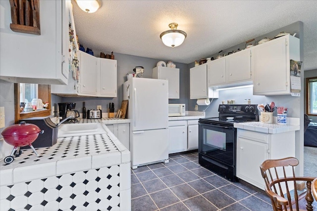 35318 Rice Rapids Rd, Bigfork Twp, MN 56628 - kitchen featuring white appliances, tile counters, white cabinets, a sink, and a textured ceiling
