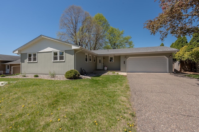 ranch-style home featuring a garage, driveway, and a front yard