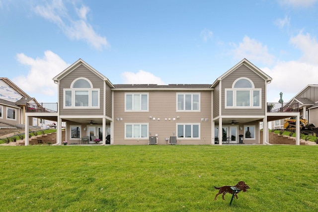 back of property featuring ceiling fan, a patio area, a yard, and central air condition unit