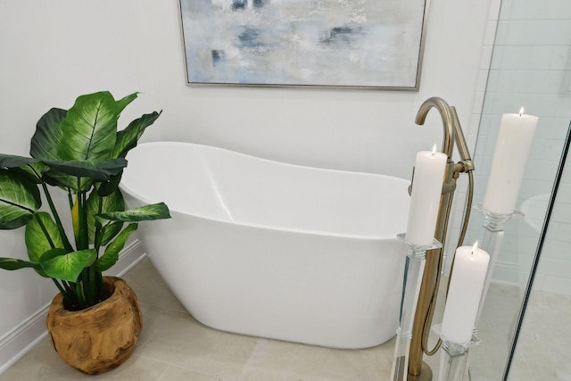bathroom featuring a soaking tub and tile patterned flooring