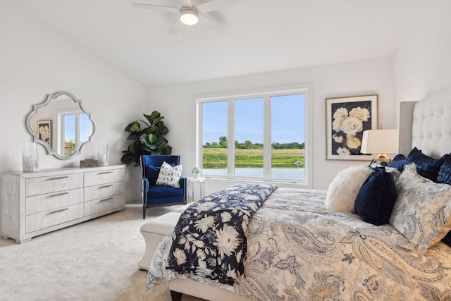 bedroom with light carpet, ceiling fan, and vaulted ceiling