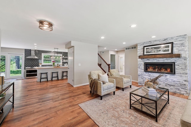 550 Wheeler Dr, Excelsior, MN 55331 - living room featuring a fireplace, stairway, wood finished floors, recessed lighting, and baseboards