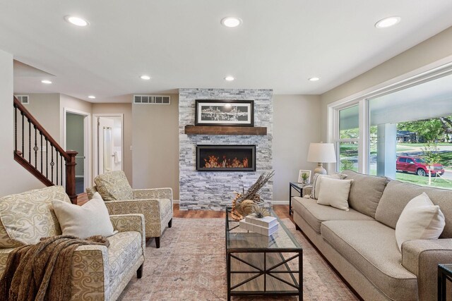 550 Wheeler Dr, Excelsior, MN 55331 - living area featuring light wood-style floors, recessed lighting, stairway, a stone fireplace, and baseboards