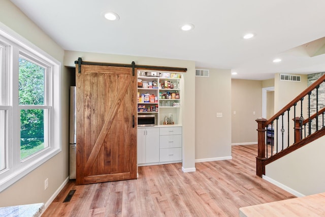 550 Wheeler Dr, Excelsior, MN 55331 - interior space with baseboards, light wood-style flooring, recessed lighting, stairway, and stainless steel microwave