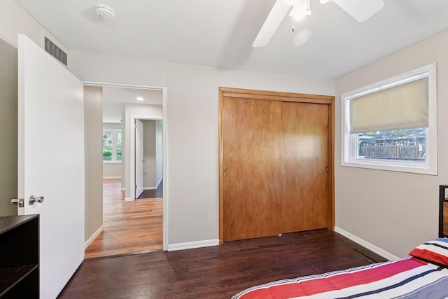 550 Wheeler Dr, Excelsior, MN 55331 - unfurnished bedroom with wood finished floors, baseboards, a closet, and ceiling fan