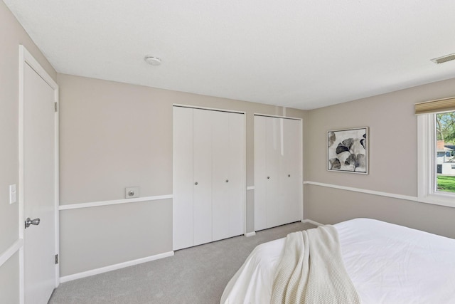550 Wheeler Dr, Excelsior, MN 55331 - bedroom featuring two closets, carpet floors, and baseboards