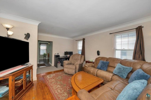 living room featuring hardwood / wood-style floors, ornamental molding, and a desk