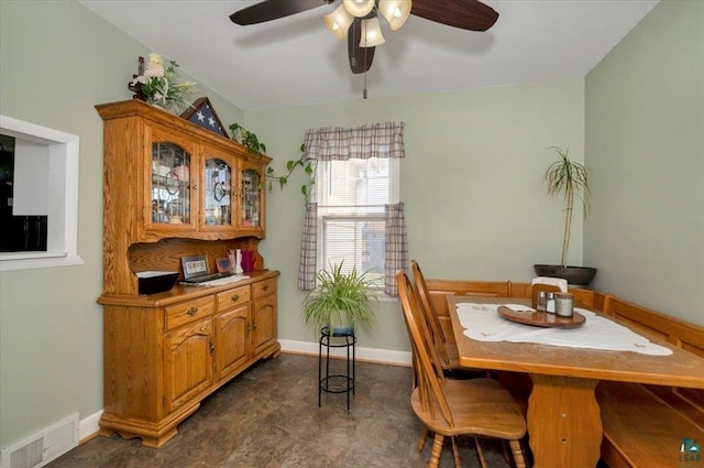 dining room featuring ceiling fan and baseboards