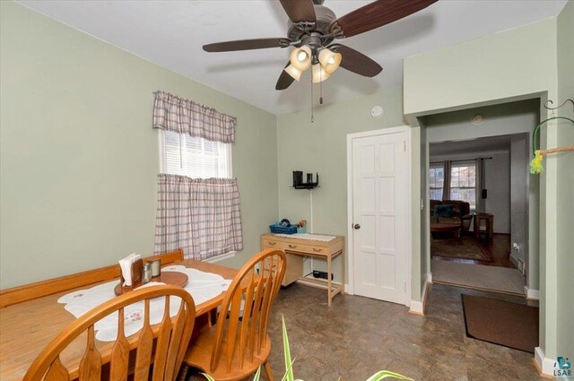 dining area featuring plenty of natural light, baseboards, and ceiling fan