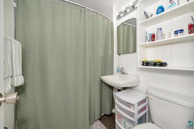 bathroom featuring toilet and a sink