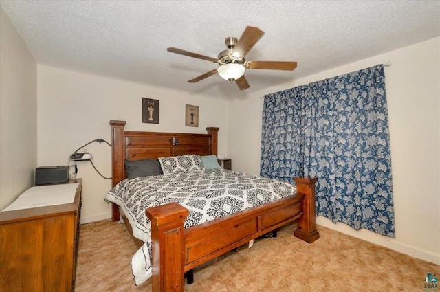 bedroom with light colored carpet, a ceiling fan, a textured ceiling, and baseboards