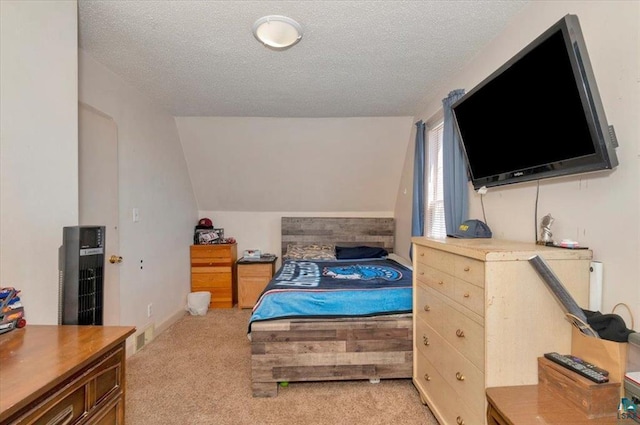 bedroom with light carpet, a textured ceiling, and vaulted ceiling