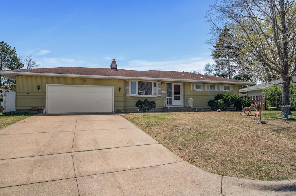 3007 66th Ave N, Brooklyn Center, MN 55429 - ranch-style home with concrete driveway, a garage, a front yard, and a chimney