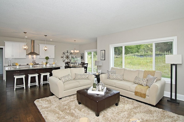19587 Hammock Ave, Lakeville, MN 55044 - living room featuring dark wood-style floors, a chandelier, and a textured ceiling