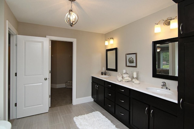 19587 Hammock Ave, Lakeville, MN 55044 - bathroom featuring double vanity, baseboards, and a chandelier