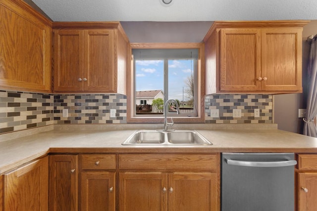 kitchen with dishwasher, light countertops, and a sink