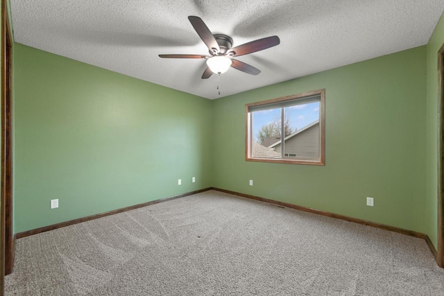 carpeted empty room featuring a ceiling fan, baseboards, and a textured ceiling