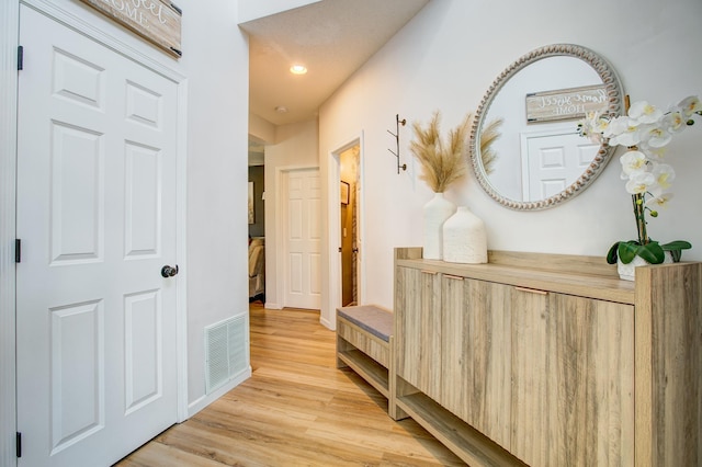 hallway featuring wood finished floors, recessed lighting, and baseboards