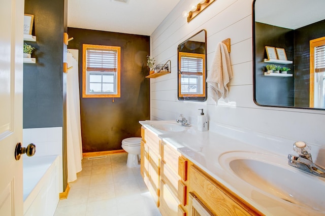 bathroom featuring plenty of natural light, toilet, a shower with curtain, and double vanity