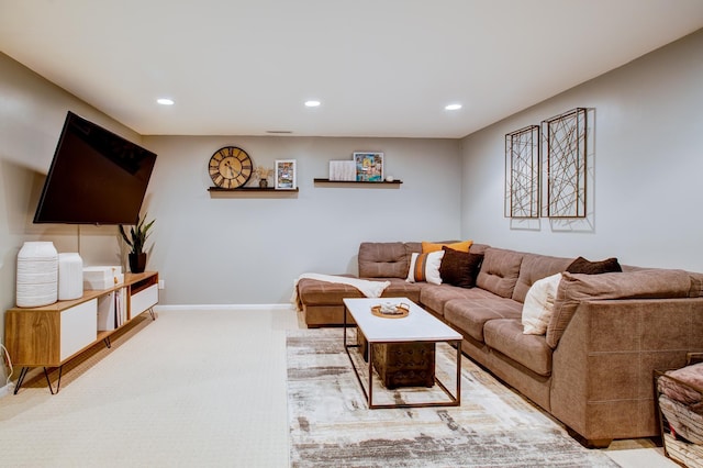 carpeted living area with recessed lighting and baseboards