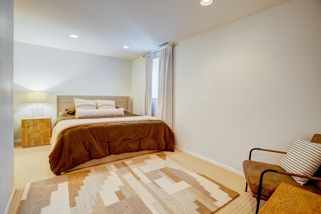 bedroom with light carpet, recessed lighting, and baseboards