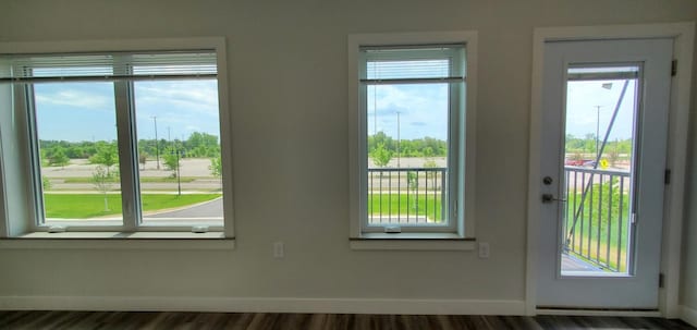 715 Lake Shore Dr NE Unit 108, Bemidji, MN 56601 - doorway with baseboards and dark wood-style floors