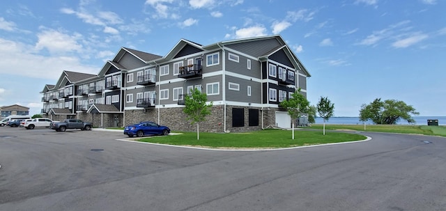 715 Lake Shore Dr NE Unit 108, Bemidji, MN 56601 - view of property with uncovered parking and a water view