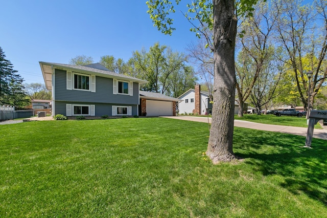 split level home featuring a garage and concrete driveway