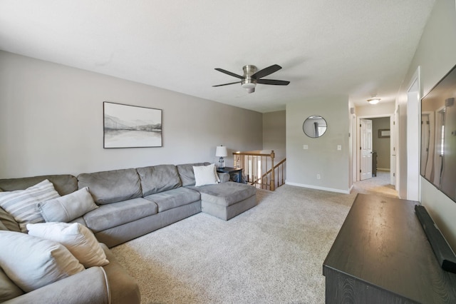 living area with carpet flooring, a ceiling fan, and baseboards