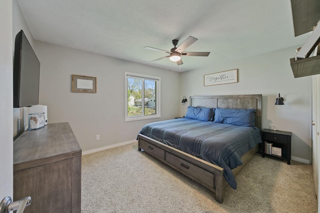 bedroom with carpet flooring, baseboards, ceiling fan, and a textured ceiling