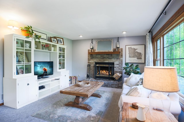 carpeted living room with a brick fireplace and recessed lighting