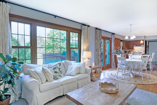 living area with a chandelier and light wood finished floors