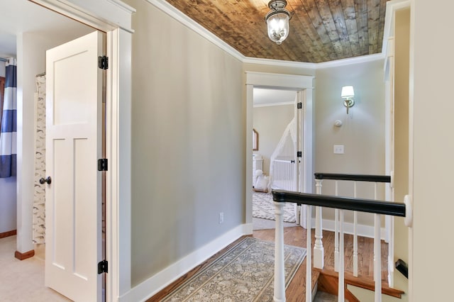 corridor with crown molding and baseboards