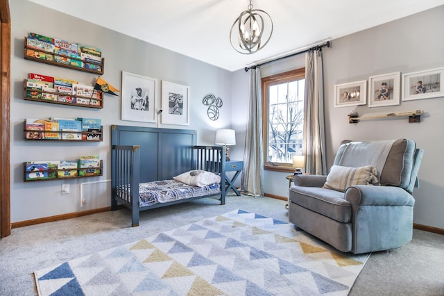 carpeted bedroom with baseboards and a chandelier