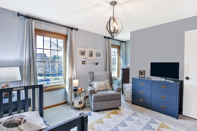 bedroom with light carpet, a chandelier, and baseboards