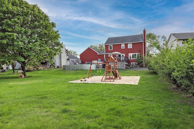 view of green lawn featuring a playground