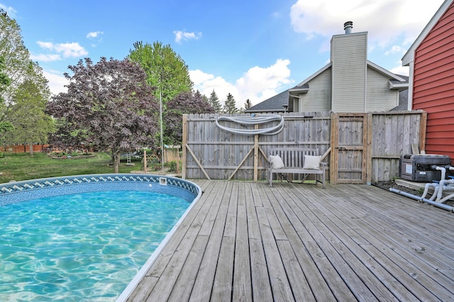 view of swimming pool with a deck