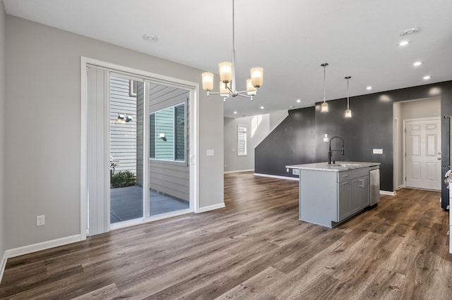 kitchen featuring a sink, dark wood-style floors, recessed lighting, stainless steel dishwasher, and open floor plan