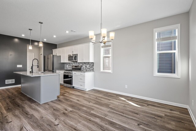 kitchen featuring appliances with stainless steel finishes, baseboards, a sink, dark wood-type flooring, and recessed lighting