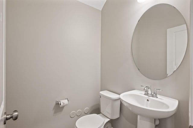 half bath with a sink and toilet