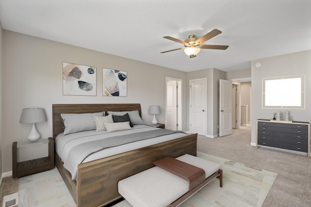 bedroom featuring light carpet, baseboards, and a ceiling fan
