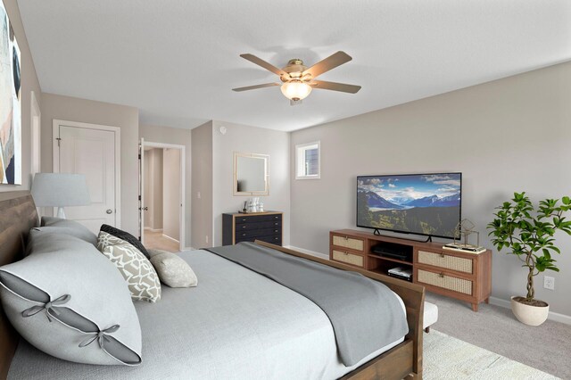 carpeted bedroom featuring baseboards and a ceiling fan
