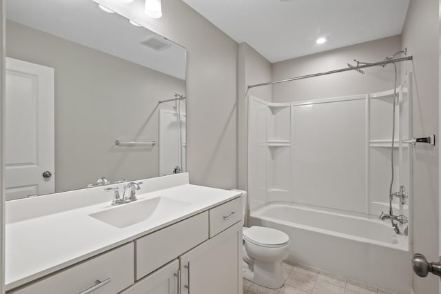 bathroom featuring toilet, tile patterned flooring, vanity, and  shower combination