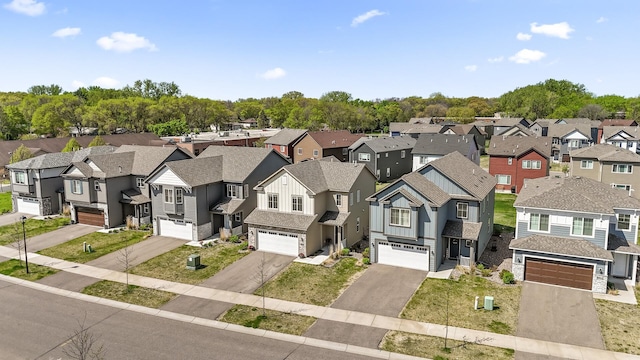 view of front of home featuring a residential view, asphalt driveway, board and batten siding, and an attached garage