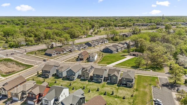 aerial view of property's location with nearby suburban area and a heavily wooded area