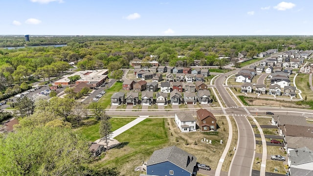 aerial view of property's location featuring nearby suburban area and a forest