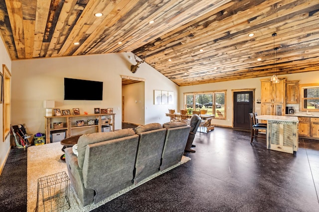 living room featuring recessed lighting, baseboards, and lofted ceiling