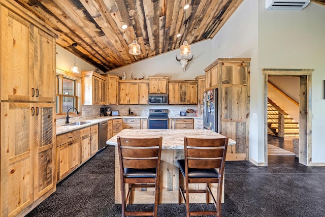 kitchen with appliances with stainless steel finishes, a sink, backsplash, hanging light fixtures, and a center island