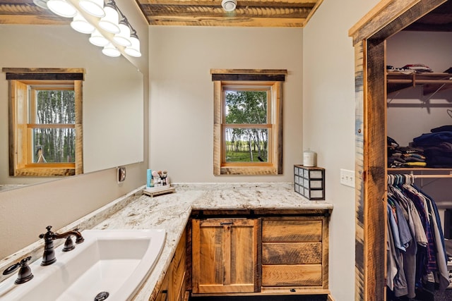bathroom featuring vanity and a walk in closet